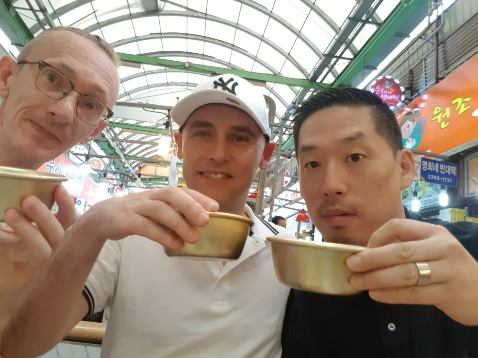 Trying 'Makali' at Gwangjang Market in Seoul, a must visit if you're on a food tour in South Korea!