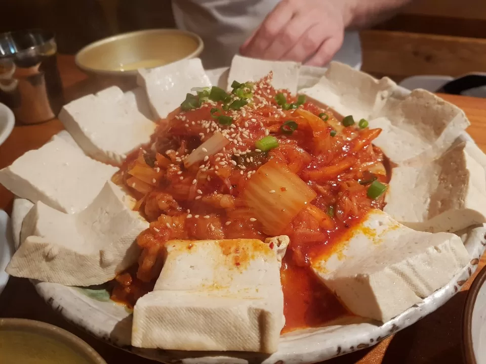 Trying a tofu dish on our food tour in South Korea!
