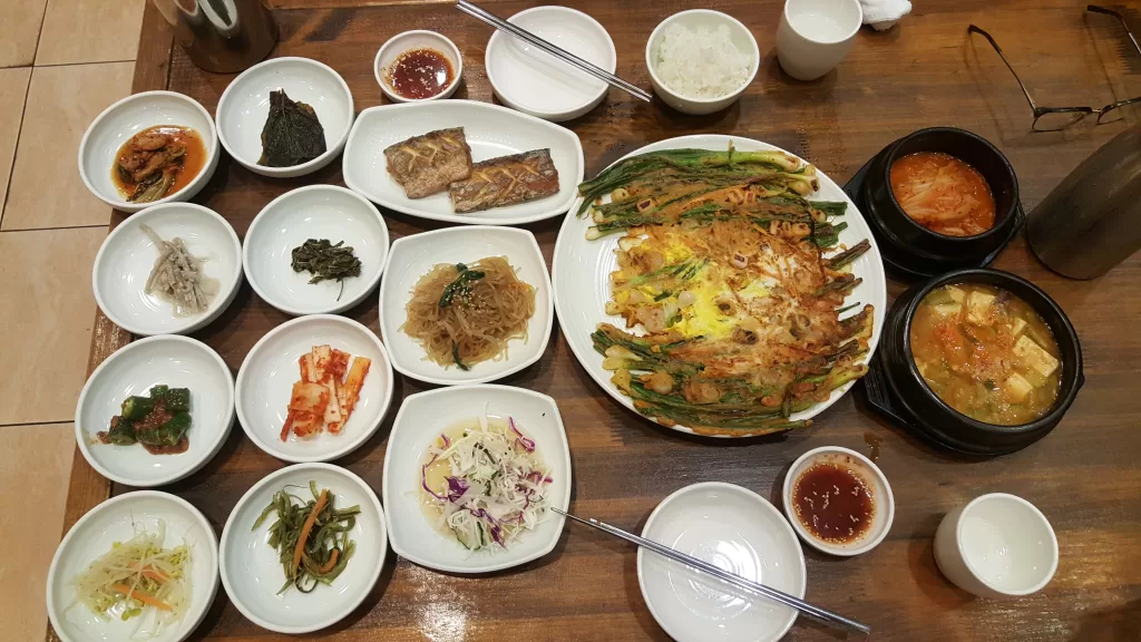 A table full of dishes of Korean food!